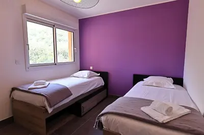 a bedroom with two beds and a large mirror at Acula Marina - Mer, Maquis Corse - T4 Lumineux in Ajaccio