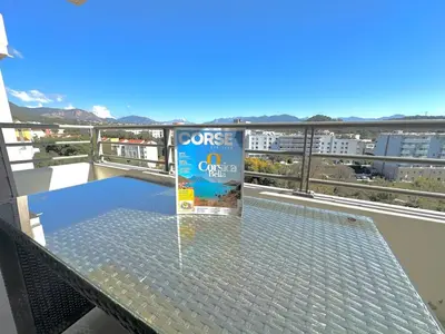 a glass table on top of a balcony at Ajaccio Apartment STUDIO in Ajaccio