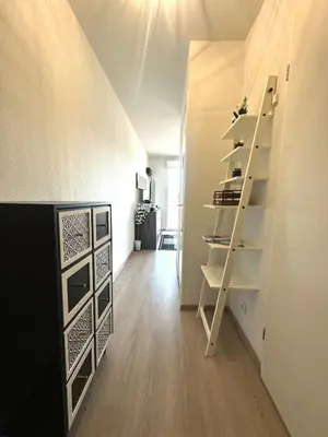 a room with a white wall with a shelf at Ajaccio Apartment STUDIO in Ajaccio