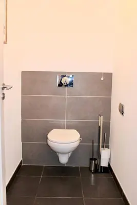 a bathroom with a white toilet in a room at 9D - appartement Bonifacio Corse in Bonifacio