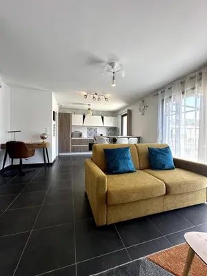 a living room with a couch and a kitchen at 9D - appartement Bonifacio Corse in Bonifacio