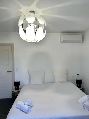 a bedroom with a white bed with towels on it at 9D - appartement Bonifacio Corse in Bonifacio