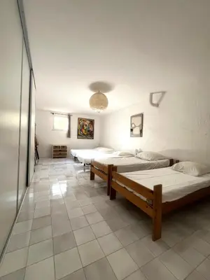 a row of beds in a large room at Villa Gardelina in Campomoro