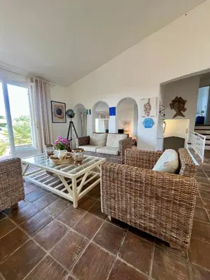 a living room with couches and a table at Villa Gardelina in Campomoro