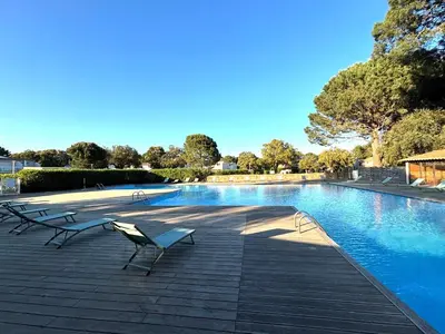 a swimming pool with benches next to ahaps at fior di cala rossa in Lecci