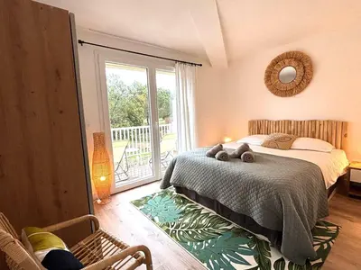 a bedroom with a bed and a sliding glass door at fior di cala rossa in Lecci