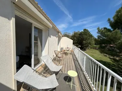 a balcony with chairs and tables on a porch at fior di cala rossa in Lecci