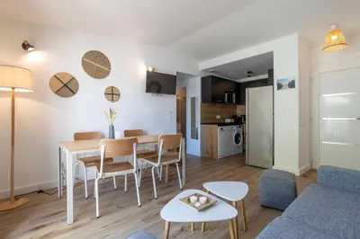 a living room and kitchen with a table and chairs at fior di cala rossa in Lecci