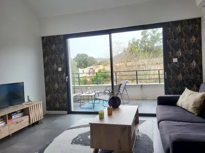 a living room with a wooden table and chairs at Appartement T2 standing in Ajaccio