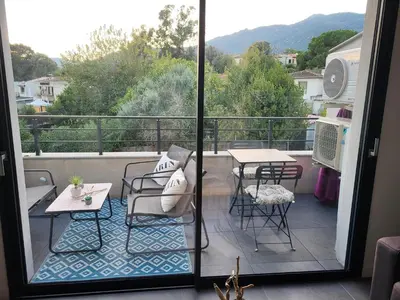 a bedroom with a bed and a vase on a table at Appartement T2 standing in Ajaccio