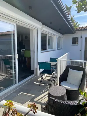 a patio with chairs and a table on a balcony at Charmant appartement 3 étoiles entièrement rénové 