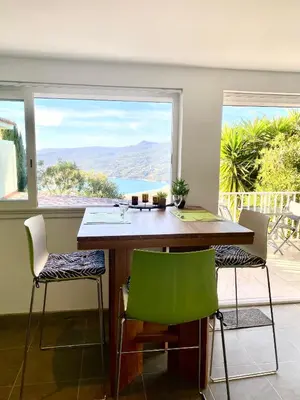 a dining room with a table and chairs with a view at Charmant appartement 3 étoiles entièrement rénové 