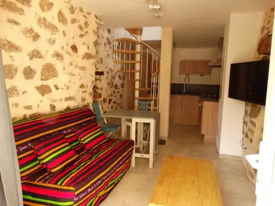 a living room with a couch and a table at Entre mer et maquis in Appietto