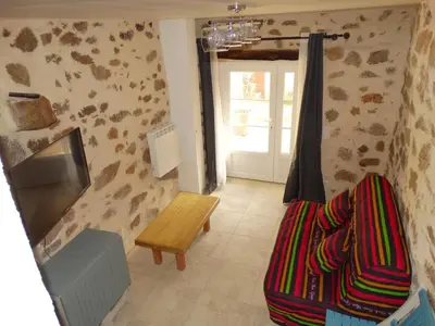a living room with a couch and a table and a window at Entre mer et maquis in Appietto