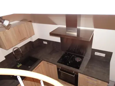 a small kitchen with a stove and a sink at Entre mer et maquis in Appietto