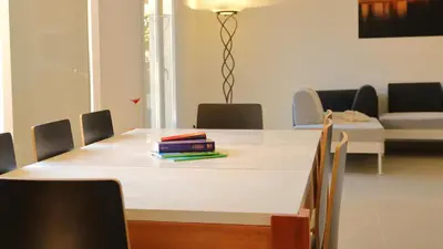 a table with books on top of it in a room at Le 42e Parallèle in Valle-di-Mezzana