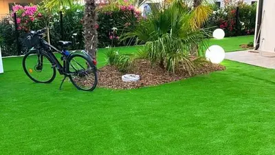 a bike parked next to a tree in a yard at Villa Isula Bella, 8 pers, piscine chauffée, proche plage in Sainte-Lucie de Porto-Vecchio