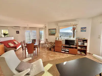 a living room with a couch and a tv at Villa 