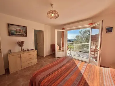 a bedroom with a bed and a sliding glass door at Villa 