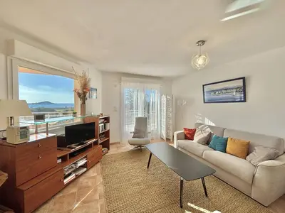 a living room with a couch and a tv at Villa 