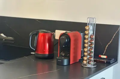 a counter top with coffee cups and a blender at Cosy T2 vue mer climatisé wifi et tout équipé refait à neuf in Ajaccio