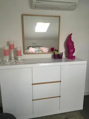 a white dresser with a mirror on top of it at Neues, modernes Steinchalet mit grosser Terrasse und Pool bei Rondinara in Bonifacio