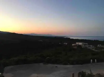 a view of the ocean at sunset at Beautiful apartment U Mare sea and mountain view in Sari Solenzara