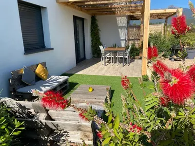 a patio with a couch and a table at Beautiful apartment U Mare sea and mountain view in Sari Solenzara