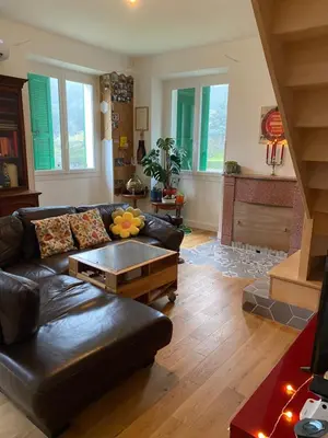 a living room with a leather couch and a table at Village vacations in Guarguale