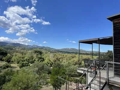 a view of the mountains from the deck of a house at A Casuccia in Zonza