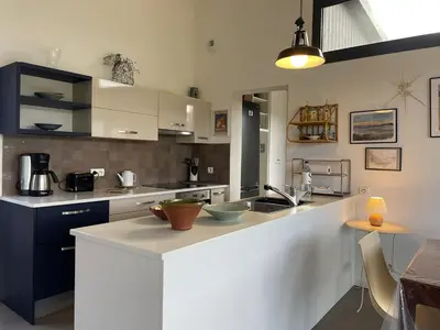 a kitchen with a large white counter in a room at A Casuccia in Zonza