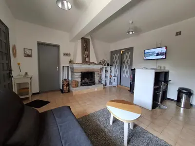 a living room with a couch and a fireplace at F2 Les Figuiers proche Ajaccio in Sarrola-Carcopino