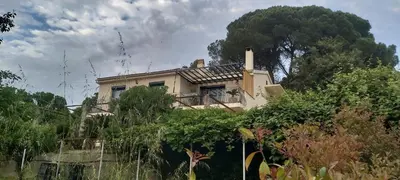 a house on top of a hill with trees at F2 Les Figuiers proche Ajaccio in Sarrola-Carcopino