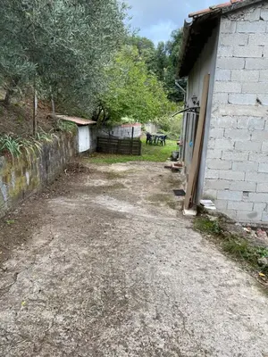 a dirt road next to a brick building at Appartement cosy Vico in Vico