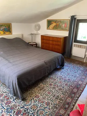 a bedroom with a bed and a rug at Appartement cosy Vico in Vico