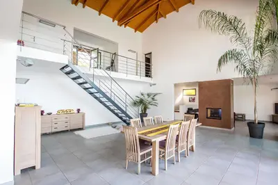 a dining room with a table and chairs and a staircase at DelSol - Villa Pool Gorgeous Sea view - by TGB in Pietrosella