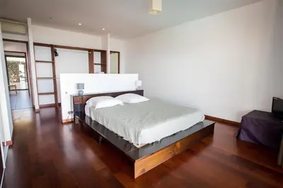 a bedroom with a bed and a wooden floor at DelSol - Villa Pool Gorgeous Sea view - by TGB in Pietrosella