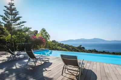 a group of chairs sitting on a deck next to a swimming pool at DelSol - Villa Pool Gorgeous Sea view - by TGB in Pietrosella