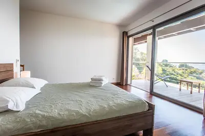 a bedroom with a bed and a large sliding glass door at DelSol - Villa Pool Gorgeous Sea view - by TGB in Pietrosella