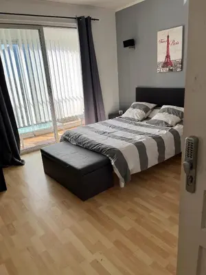 a bedroom with a bed and a large window at olmareddu in Alata