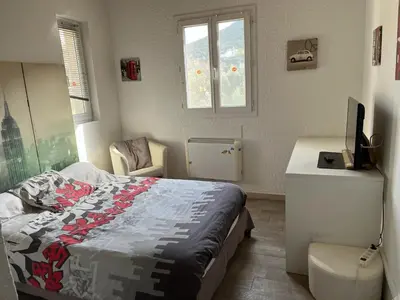 a bedroom with a bed and a desk and window at olmareddu in Alata