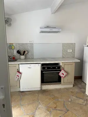 a kitchen with a stove and a white dishwasher at olmareddu in Alata