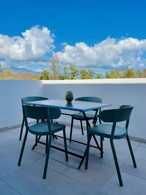 a table and chairs sitting on a patio at Appt Lumineux pieds dans l'eau N181 in Linguizzetta