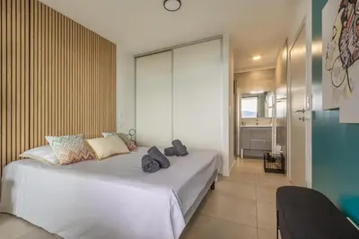 a bedroom with a large white bed in a room at Le Calypso B01 - Climatisé avec vue mer in Grosseto-Prugna