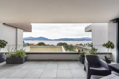 a balcony with chairs and a view of the water at Le Calypso B01 - Climatisé avec vue mer in Grosseto-Prugna