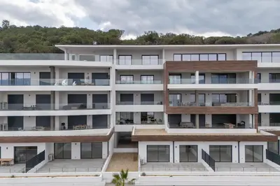 an apartment building with balconies and trees in the background at Le Calypso B01 - Climatisé avec vue mer in Grosseto-Prugna