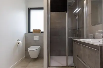 a bathroom with a shower and a toilet and a sink at Le Calypso B01 - Climatisé avec vue mer in Grosseto-Prugna