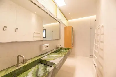 a bathroom with a large sink and a mirror at Hôtel VILLA MAIER in Sainte-Lucie de Porto-Vecchio