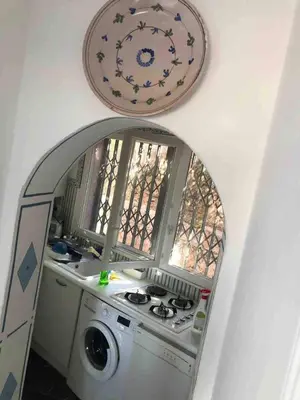 a kitchen with a mirror and a washing machine at Casetta indipendente con vista a Santa Giulia in Porto-Vecchio