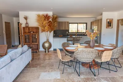 a living room with a couch and a table and chairs at Villa Campemu Di Lecci in Lecci
